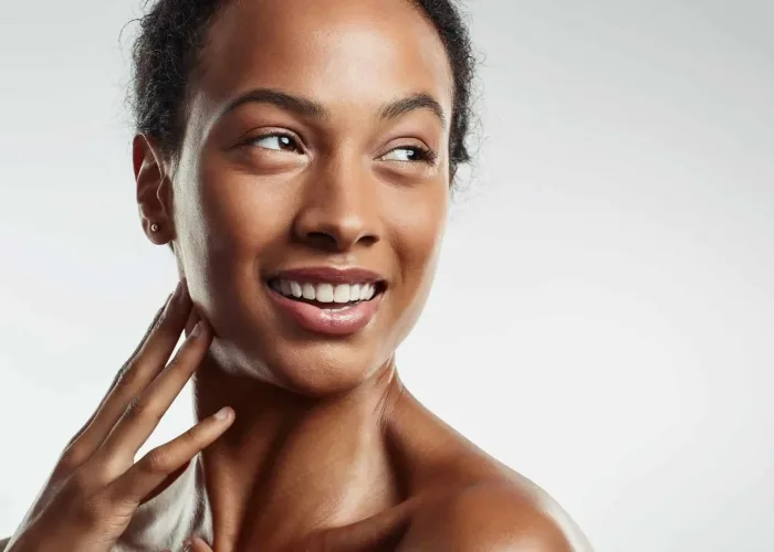 woman touching her neck