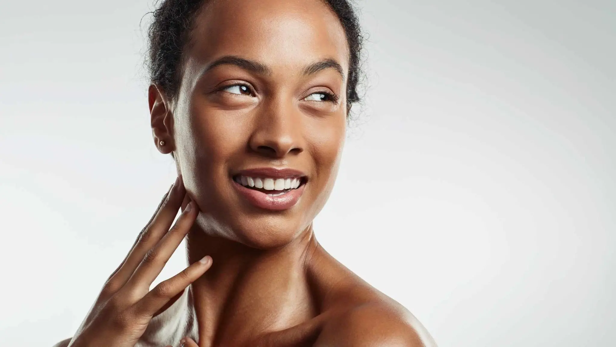 woman touching her neck